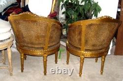 Pair of Vintage Muted Gilded Cane Caned Bergere chairs with Musical Violin crest